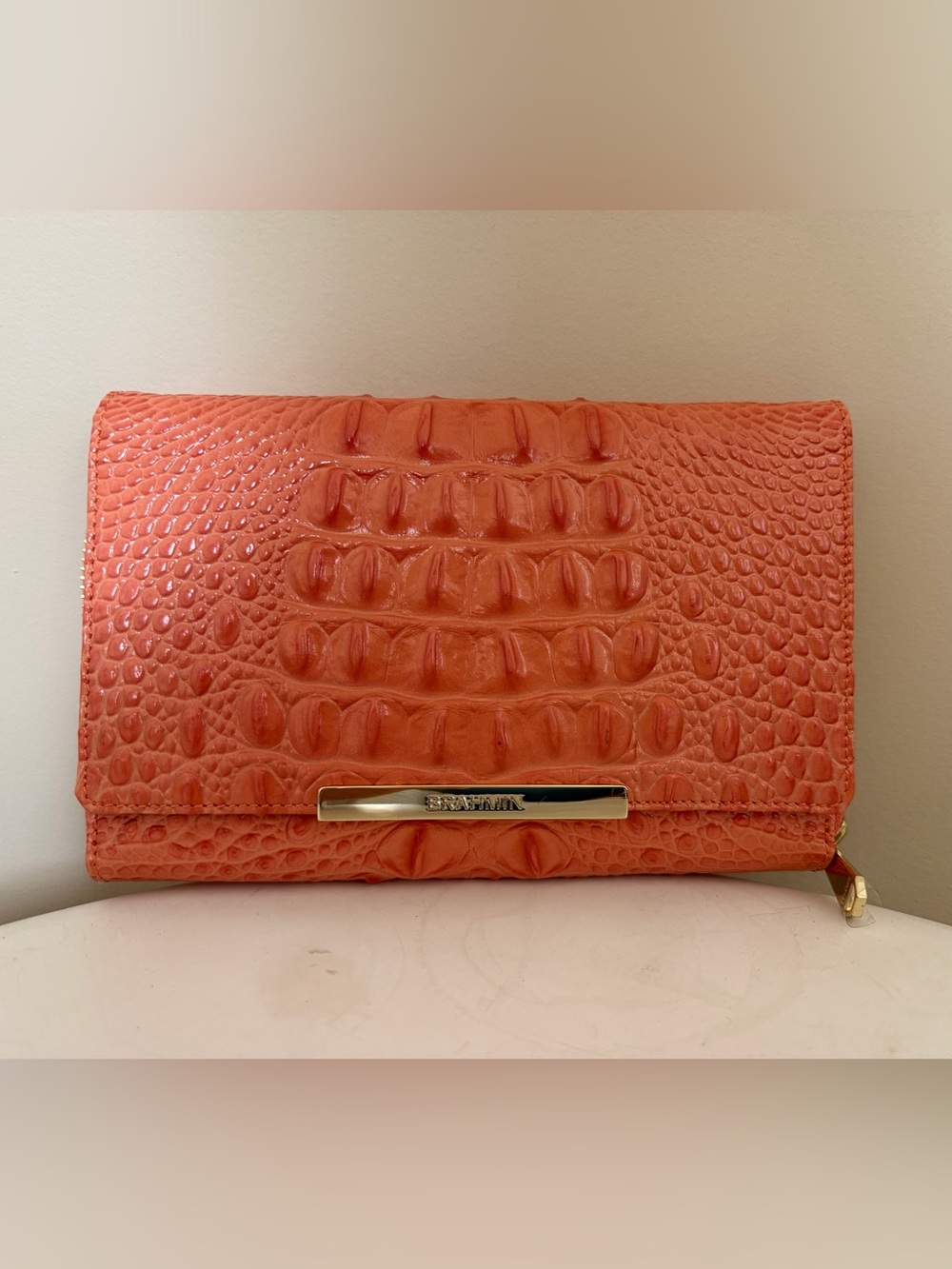 Brahmin flap front clutch wallet in a creamsicle shade crocodile
